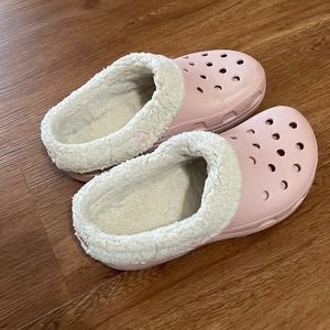 Pink Crocs with white lining.